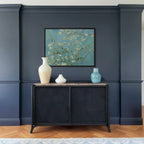 Framed Blossoming Almond Tree by Vincent van Gogh wall art hanging on a wall in a modern interior.