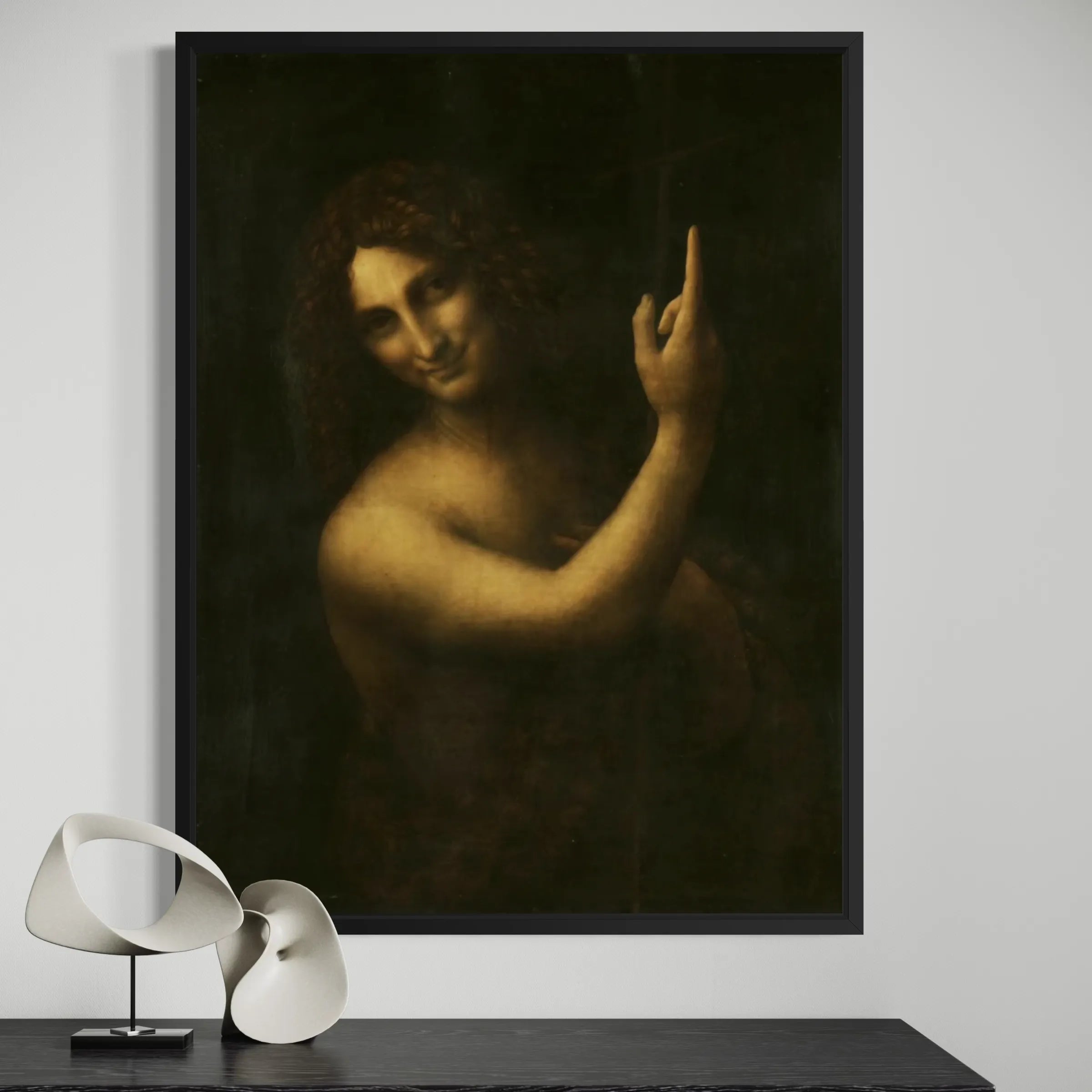 Saint John the Baptist by Leonardo da Vinci wall art hanging on a wall as elegant home decor.